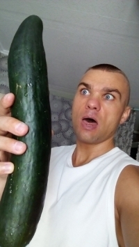 Man with a big cucumber
